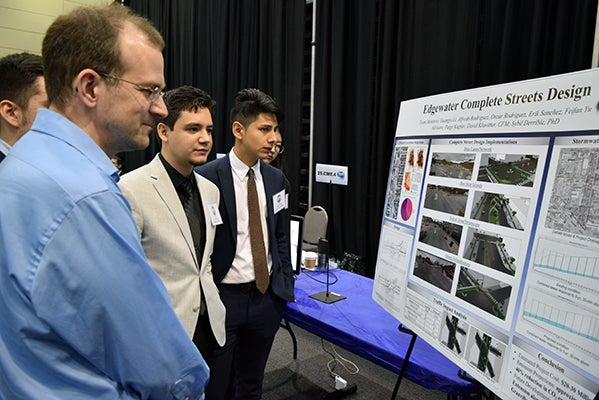 Students observe posters