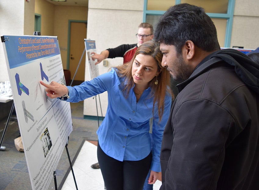 person presenting her research poster