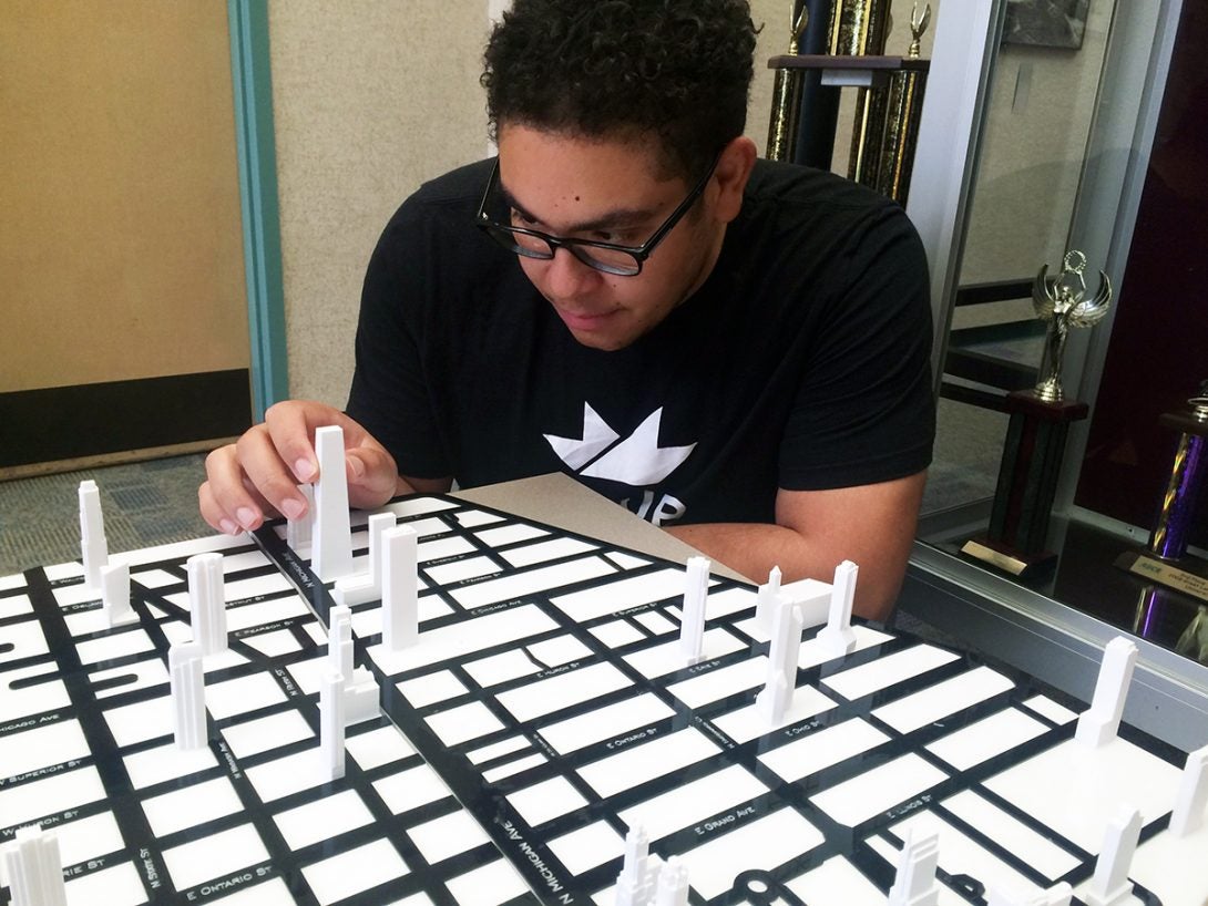 student working on scale model of Chicago's downtown