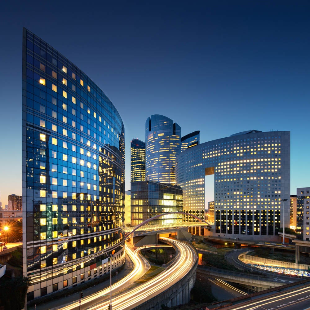 buildings and roadways in a city at night