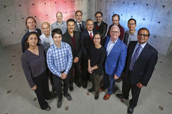 A group of CME faculty advisors poses in the High-Bay Structures Laboratory
