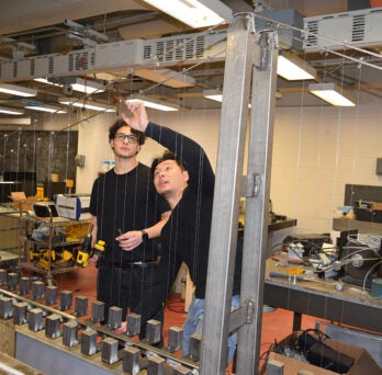 Students work on a model of the Messina bridge in UIC Distinguished Professor and Christopher B. and Susan S, Burke Chair in Civil Engineering Farhad Ansari's lab at UIC 